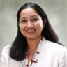 Headshot of Sneha Mishra, MD in front of a light gray background wearing a white jacket