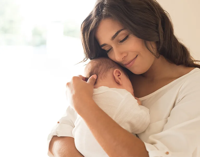 Image of a woman holding her baby