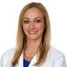 Headshot of Katherine Duncan, MD in front of a white background wearing a white coat with a blue shirt