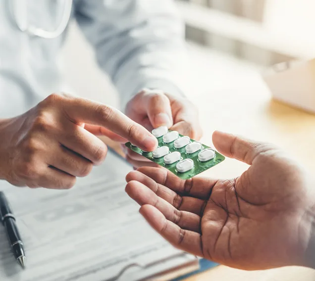Doctor handing a prescription to a patient