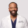 Headshot of Jerome Puryear, Jr., M.D., MBA, DABOM, DABR, in front of a white background with a white coat on