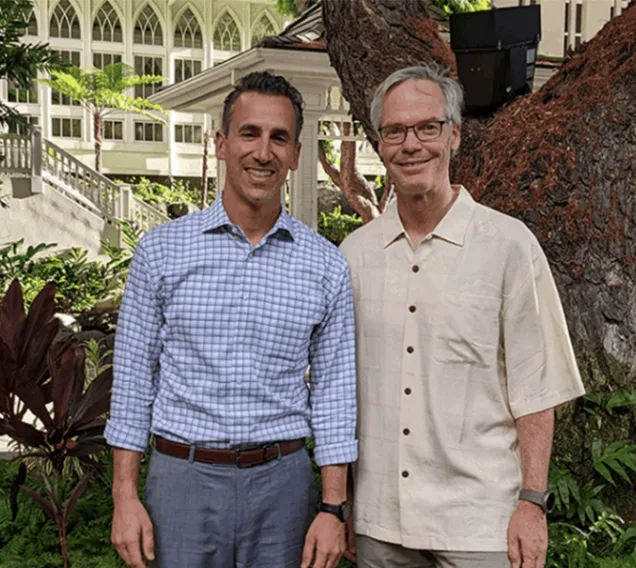 Image of Drs. Ethan Lazarus and Anthony Auriemma standing in front of a tree