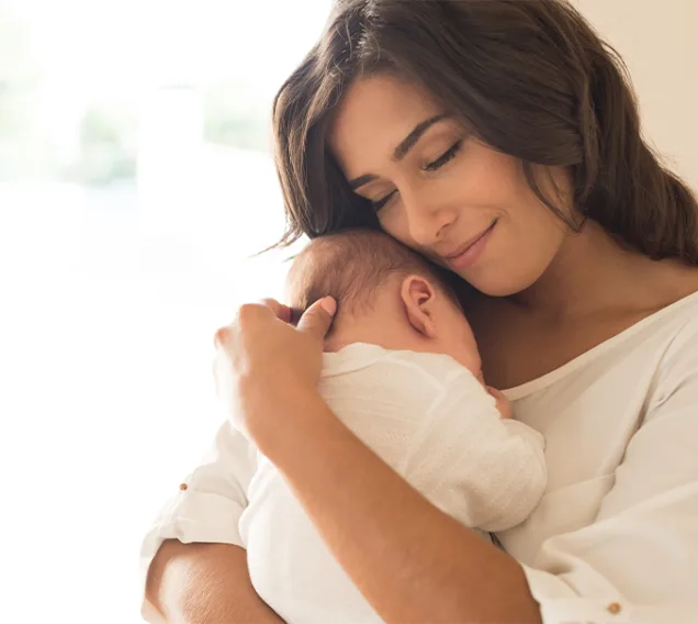 Image of a woman holding her baby