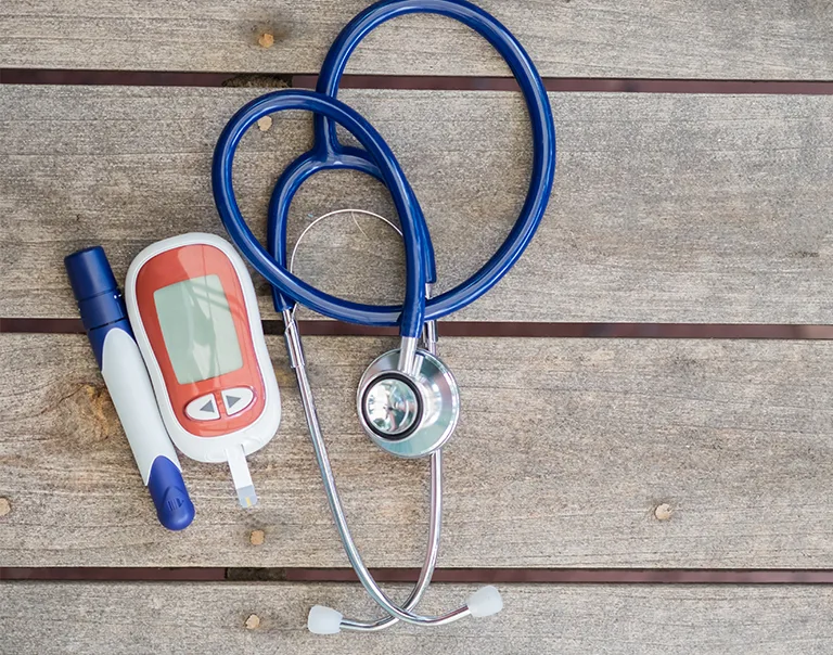 Image of a stethoscope and an insulin pen
