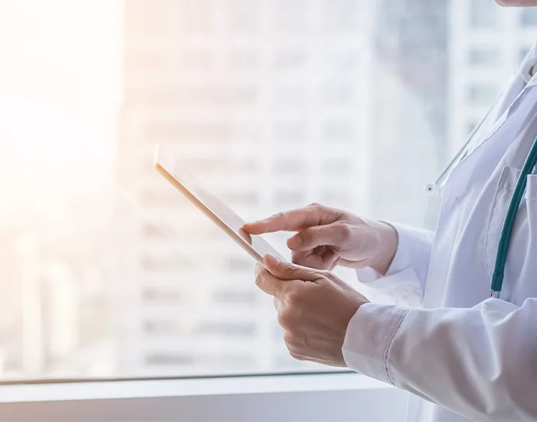 Side shot of a doctor on an ipad