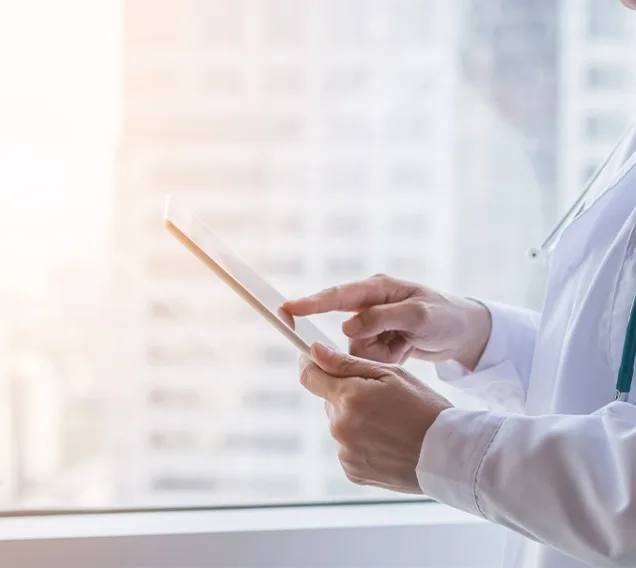 Side shot of a doctor on an ipad