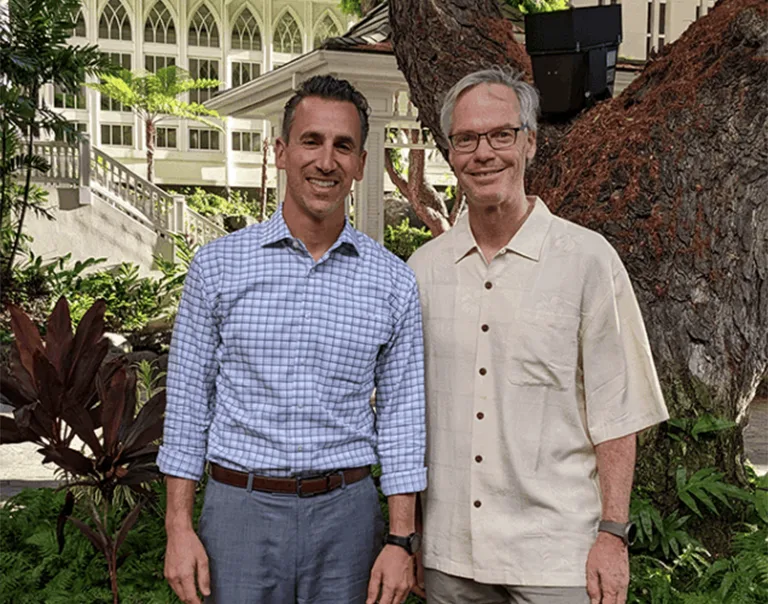 Image of Drs. Ethan Lazarus and Anthony Auriemma standing in front of a tree