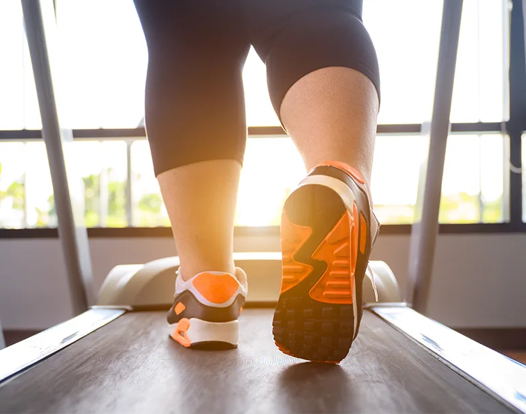 image of a persons feet walking on the treadmill