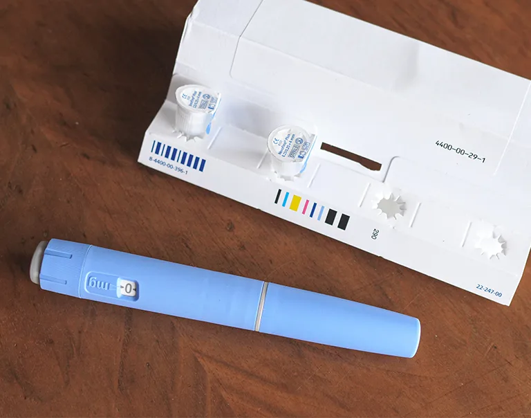 image of an injectable diabetes/weight loss medication on a table next to it's box