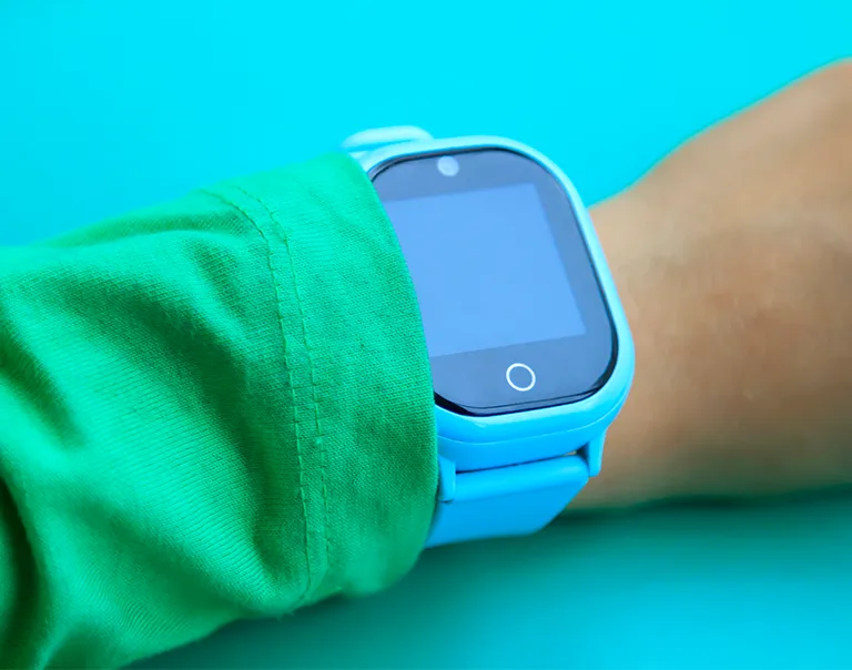 image of a child's wrist with a electronic watch