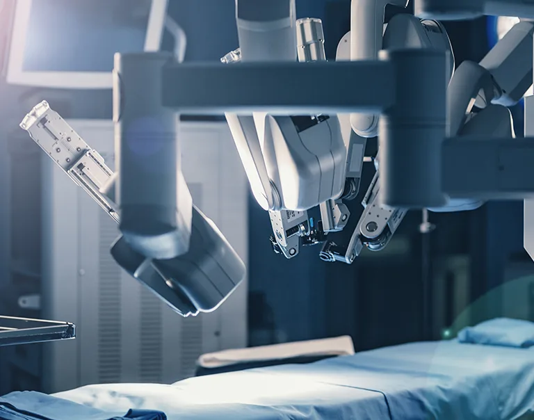 image of an operating room with a bed and a machine in the top right corner