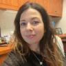 Headshot (selfie) of Alina Elperin, MD, sitting in a desk chair with a desk behind her.