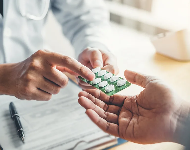 Doctor handing a prescription to a patient
