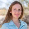 Headshot of Nicole Garber, MD wearing a blue shirt with fall trees in the background