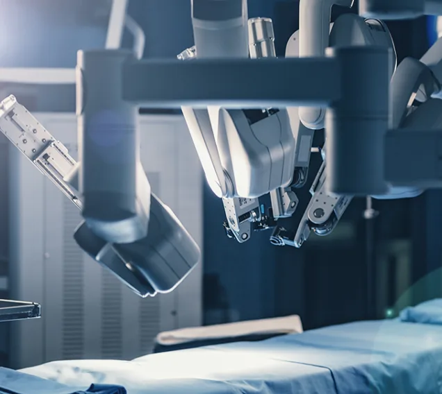 image of an operating room with a bed and a machine in the top right corner