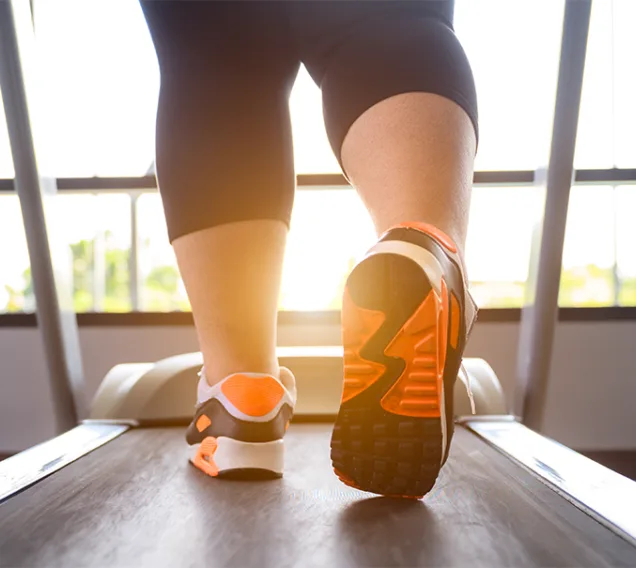 image of a persons feet walking on the treadmill