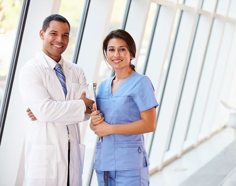 two doctors standing next to each other holding clipboards